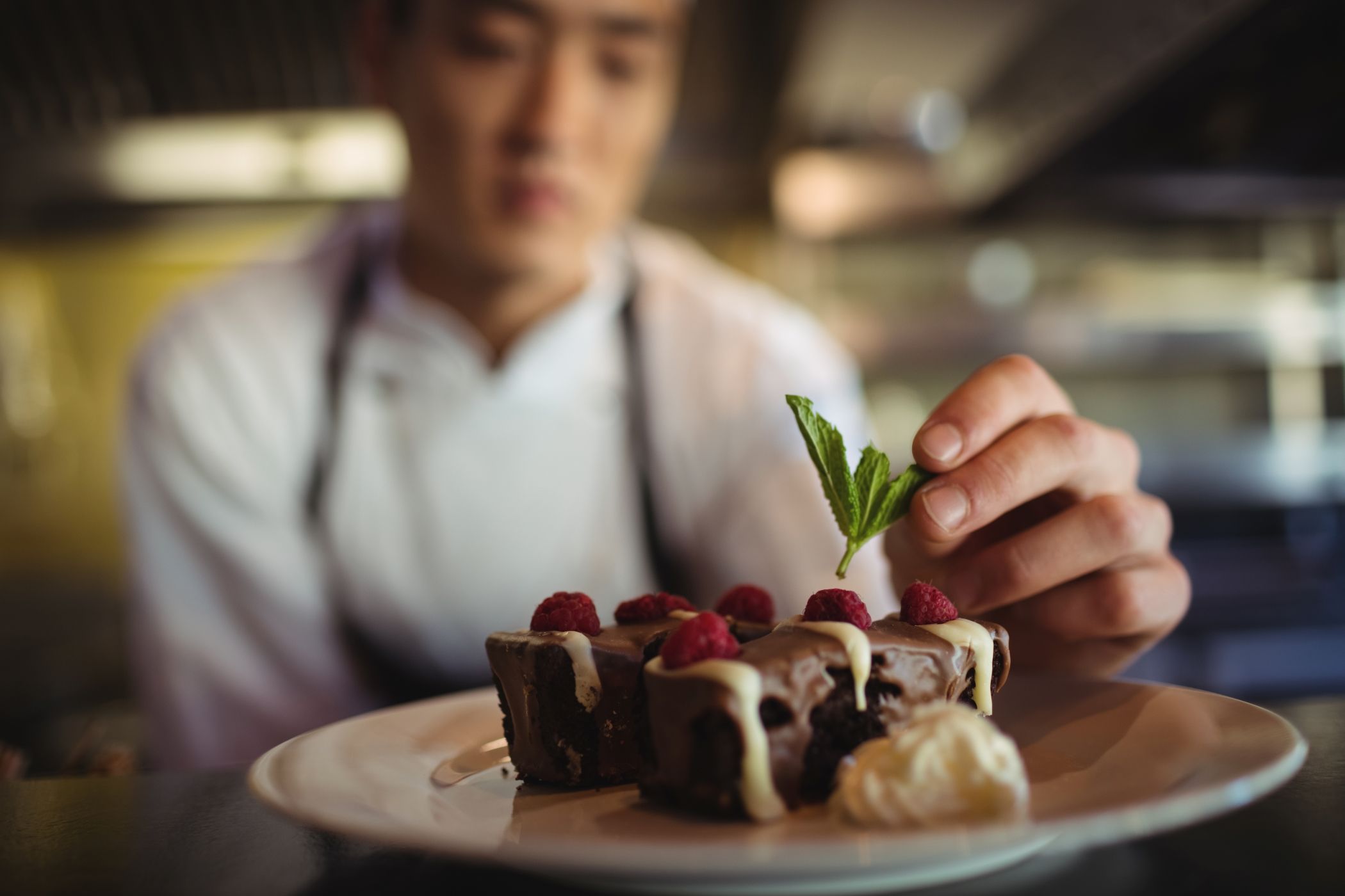 Male chef garnishing dessert plate at a Villa in Miami